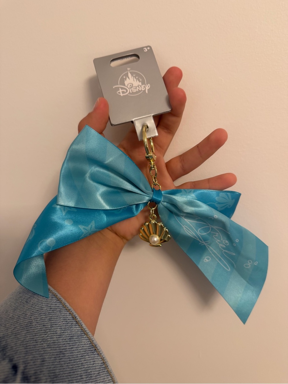 Disney Teal Ribbon Keychain with Gold Shell and Pearl Charm